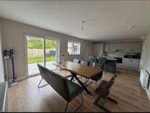 a kitchen and dining room with a table and chairs at Lighthouseview - Cahersiveen in Cahersiveen