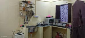 a small kitchen with a sink and a microwave at Khans villa in Hyderabad