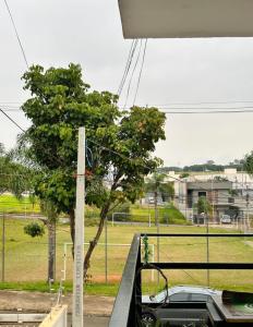 a car is parked in front of a field at Kit Net Cidade Universitária in Limeira