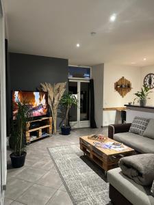 a living room with a couch and a flat screen tv at Chez Louis in Saint-Flour