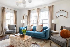 a living room with a blue couch and two chairs at Golden Gazelle in Atlanta