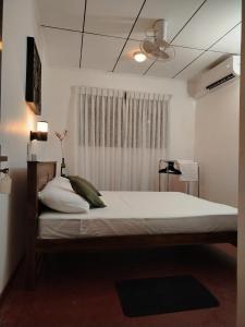 a bedroom with a large bed with a ceiling fan at Villa Green Garden in Hikkaduwa +82 photos