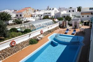 arial view of a swimming pool at a resort at Hostal S'Algaret in Fornells