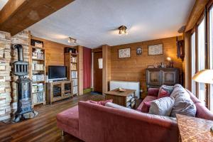 a living room with a couch and a fireplace at Chalet Fauvette in La Tzoumaz