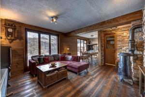 a living room with a couch and a table at Chalet Fauvette in La Tzoumaz