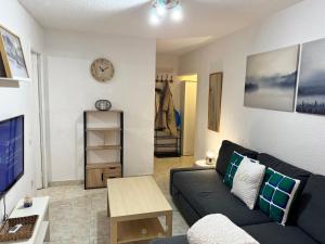 a living room with a couch and a tv at PROBER_NEVADA II in Pas de la Casa