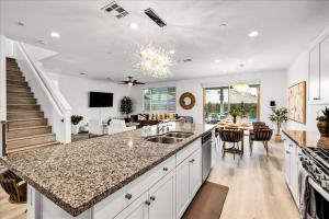 a kitchen with a counter top and a living room at Oh la la Coachella in Coachella
