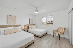 a bedroom with two beds and a chair and a window at Oh la la Coachella in Coachella +71 photos