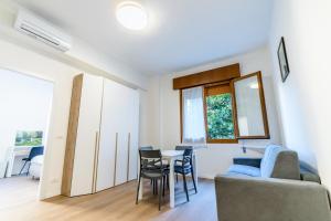 a living room with a table and chairs and a couch at Ipin Home in Mestre