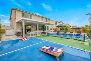 a house with a pool and a tennis court at Oh la la Coachella in Coachella
