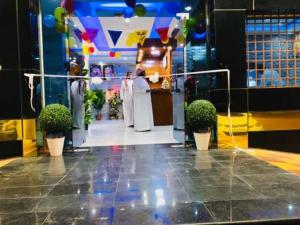 a group of people standing in a room with plants at تاج الملكه للشقق المخدومة in Ḑirs