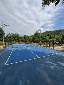 a blue tennis court with two lights on it at Chậm Viên Le Jardin in Thanh Lâm