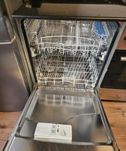 an empty dishwasher with a white appliance in it at Appartement blue sky unique et élégante in Lomé