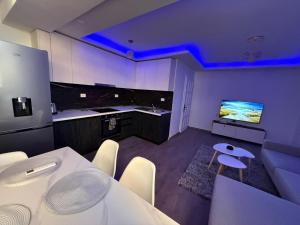 een kamer met een tafel en een tv. bij Shkodra Apartment AR in Shkodër