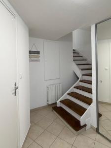 een trap in een witte kamer met een glazen deur bij Rive Gauche in La Celle-sous-Gouzon