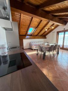 a kitchen and dining room with a table and chairs at Al Cacciatore in Gallio +6 photos