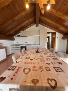 a large wooden table with hearts on it in a kitchen at Al Cacciatore in Gallio