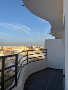 a balcony with a view of a city at Rassyl Résidence in Jendouba +4 photos