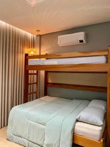 a bedroom with two bunk beds and a window at Ap Da Ilha in Alter do Chao