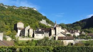 a village in the mountains with a church at Entre sel et vignes in Lons-le-Saunier