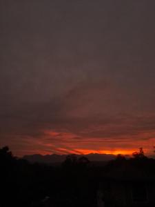 a sunset in the sky with mountains in the background at Mountain View in Bandarawela +2 photos