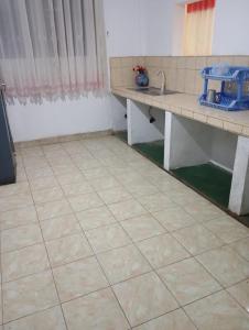 a kitchen with a sink and a tiled floor at Mountain View in Bandarawela