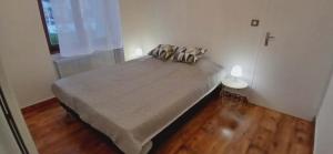 a bedroom with a bed with two pillows on it at Entre sel et vignes in Lons-le-Saunier