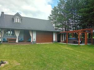 a house with a large yard with a gazebo at Domek letniskowy u Doroty in Walne