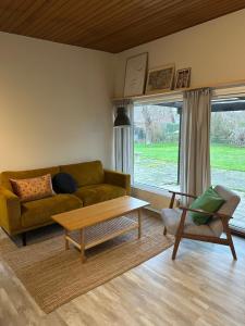 a living room with a couch and a coffee table at Rødbyhavn Nordic Villa in Rødby