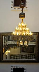 a picture of a chandelier in front of a mirror at Dar Karaouyine Panoramic in Fez