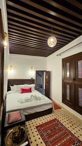 a bedroom with a large bed in a room at Dar Karaouyine Panoramic in Fez