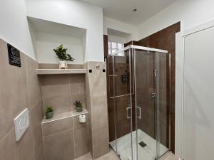 a shower with a glass door in a bathroom at Umberto Home 303 in Catania +83 photos