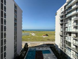 a view of the ocean from between two buildings at Edificio Salinas del Mar - Pozos Colorados in Santa Marta