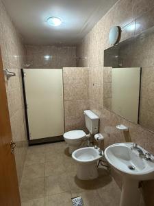 a bathroom with a toilet and a sink at Cabañas La Cautiva in Tanti +26 photos