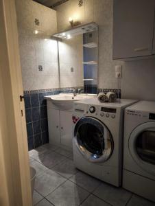 een keuken met een wasmachine en een wastafel bij Bel Appartement Lumineux, 70m2, 3 Chambres, Proche Zénith et Hippodrome de Caen in Caen