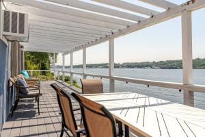 un portico con tavolo, sedie e acqua di Riverfront Home with a View! a Groton