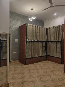 an empty room with curtains in a room with a room at Green Olive GoStays Best Dormitory and Rooms in Lucknow in Lucknow