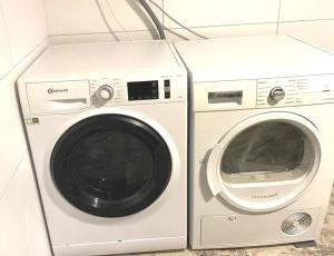 a washer and a washing machine sitting next to each other at Burgweg Living in Bad Wildungen