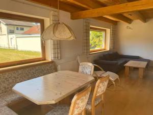 a living room with a table and chairs and a couch at Ferienhaus Wolfurt in Wolfurt