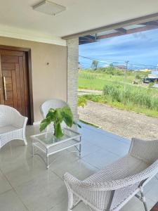 a living room with a glass table and chairs and a view at Casa Campos do Mar in Conde