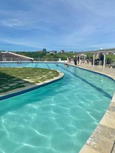 a large swimming pool with turquoise water at Casa Campos do Mar in Conde