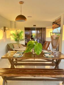 a wooden table with a potted plant in a living room at Casa Campos do Mar in Conde