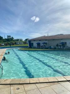 a swimming pool with blue water in front of a building at Casa Campos do Mar in Conde +22 photos
