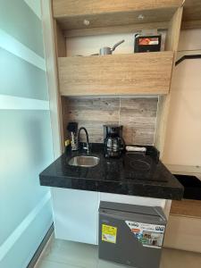 a kitchen counter with a sink in a room at Tiny Spot in Ocaña