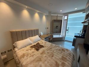 a bedroom with a large bed with a star on it at Tiny Spot in Ocaña +3 photos