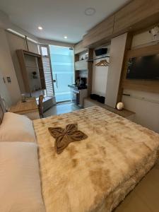 a bedroom with a large bed with a bow on it at Tiny Spot in Ocaña