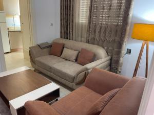 a living room with a couch and a table at حي النصر 2 in Ariana