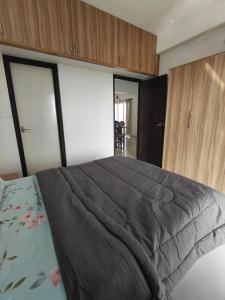 a bedroom with a large bed and wooden cabinets at Sosh service apartments in Mangalore