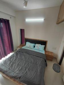 a bedroom with a large bed in a room at Sosh service apartments in Mangalore