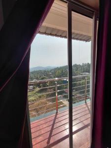 a room with a view of a balcony at Sosh service apartments in Mangalore